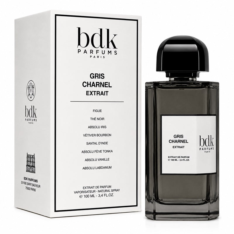 Bdk Parfums Paris Gris Charel Extrait perfume bottle next to its white packaging box, featuring a dark gray glass bottle and a black cap on a white background.