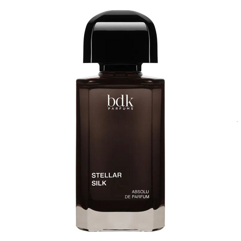 A bottle of BDK Parfums Stellar Silk Absolu de Parfum, featuring a dark brown glass bottle with a glossy black cap, set against a plain white background.