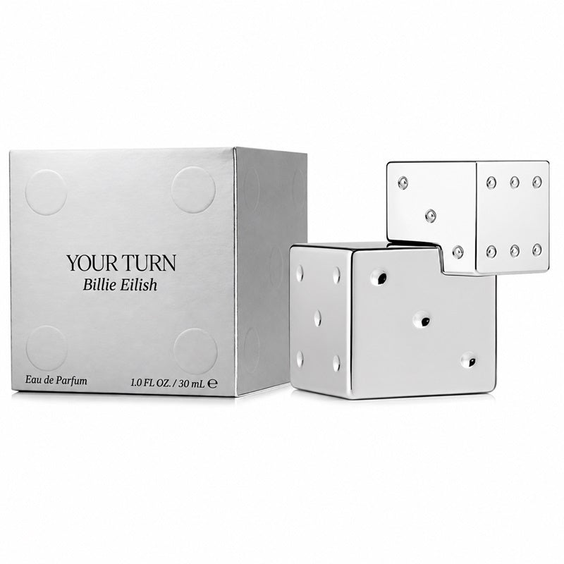 Billie Eilish Your Turn 100ml Eau de Parfum silver-chrome dice bottle beside its matching metallic silver presentation carton with black branding and embossed circular detailing on a clean white background.