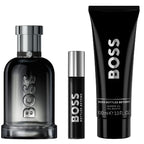 BOSS perfume set with a bottle, rollerball, and shower gel on a white background