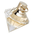 A clear glass bottle of Chopard Brilliant Wish Eau de Parfum with a gold-colored cap.