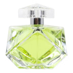 Clear glass perfume bottle with green liquid on a white background