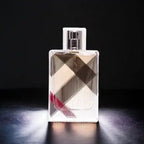 Perfume bottle with checkered design on dark background