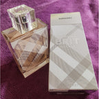 Burberry perfume bottle and packaging on a purple textured background