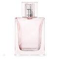 A glass bottle of Burberry Brit Sheer Eau de Toilette with a pink hue and a transparent cap.