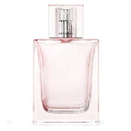 A glass bottle of Burberry Brit Sheer Eau de Toilette with a pink hue and a transparent cap.