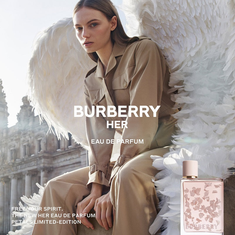 Burberry Her Eau de Parfum advertisement with a model in a trench coat and angel wings.