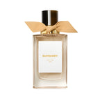 Burberry perfume bottle with a gold bow on a white background