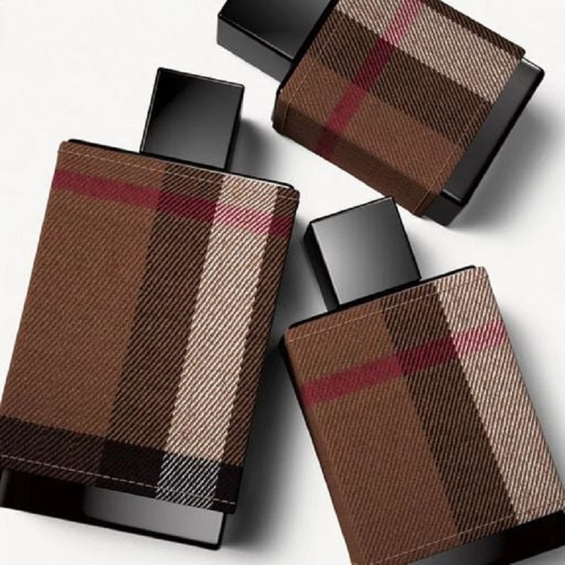 Three perfume bottles with plaid design on a white background