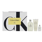 Calvin Klein gift set featuring a large patterned box with a yellow label, alongside three matching toiletry bottles and tubes in frosted white and light gray.
