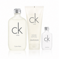 Calvin Klein CK One body wash set featuring a large frosted bottle, a tall translucent tube, and a smaller clear bottle, all with silver caps on a white background.