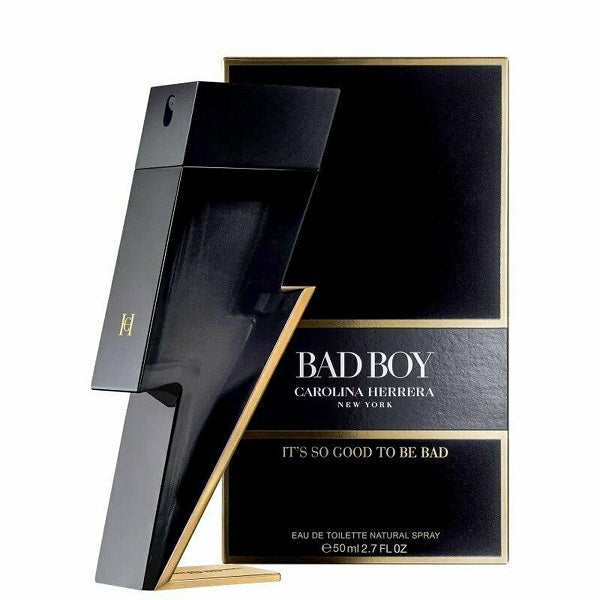 Package and spray bottle of 'Bad Boy' Eau de Toilette by Carolina Herrera, with black and gold color scheme.