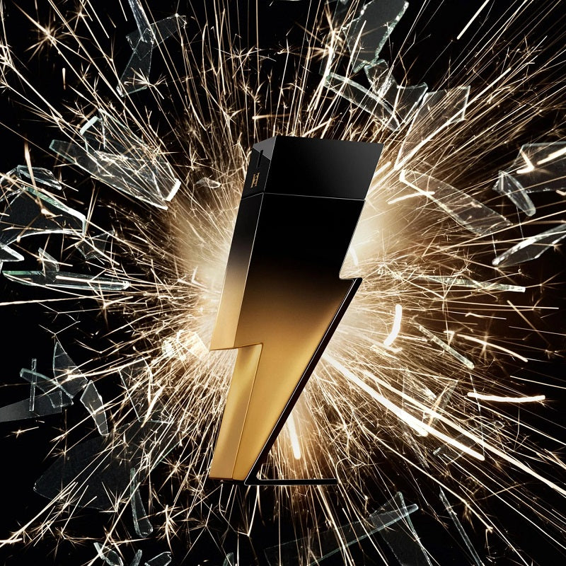 Black and gold product with sparks and shattered glass on a dark background