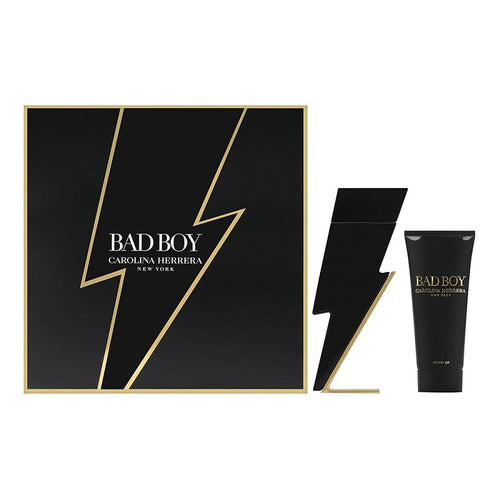 Gift set of Bad Boy by Carolina Herrera, including a 100ml Eau de Toilette spray bottle and a 100ml scented shower gel, packaged in a black box with gold accents.