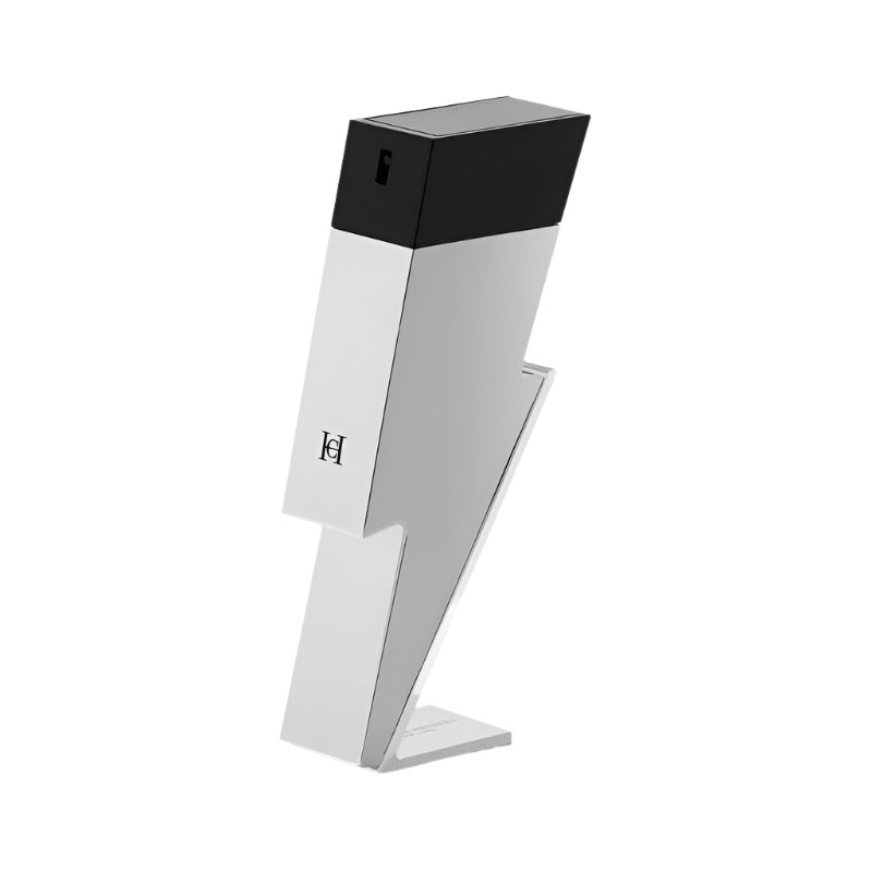 A chrome bottle of Bad Boy Superstars Eau de Toilette by Carolina Herrera, with a black cap, positioned on a stand.