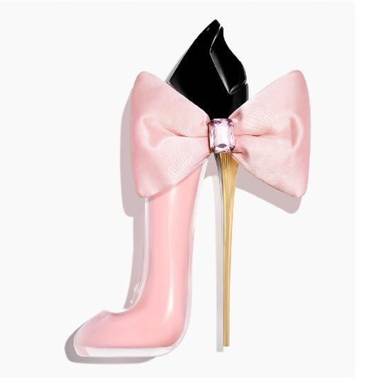 Pink high-heeled shoe with a bow and gemstone on a white background