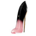 A bottle of Good Girl Blush Elixir Eau De Parfum by Carolina Herrera, featuring a design resembling a high-heeled shoe with a black to pink gradient.