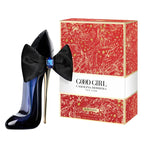 Black high-heeled shoes with a bow and Carolina Herrera 'Good Girl' perfume box on a white background