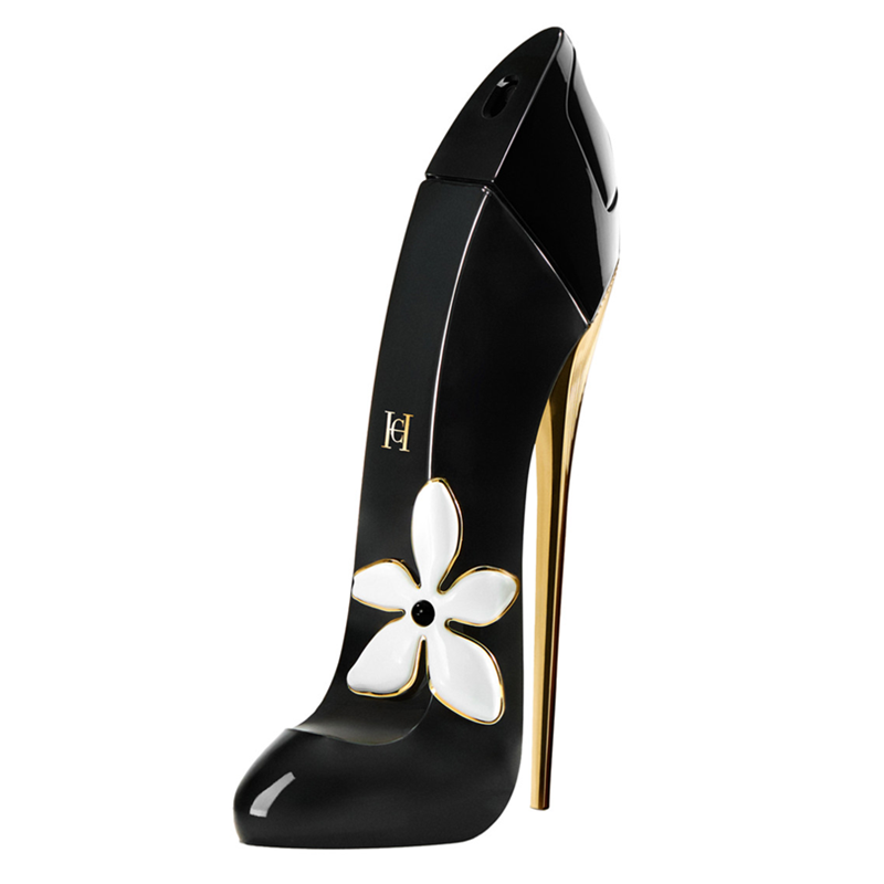 A high-heeled perfume bottle designed like a black stiletto shoe, featuring a glossy black finish, a gold stiletto heel, and a white flower with gold trim on the side.