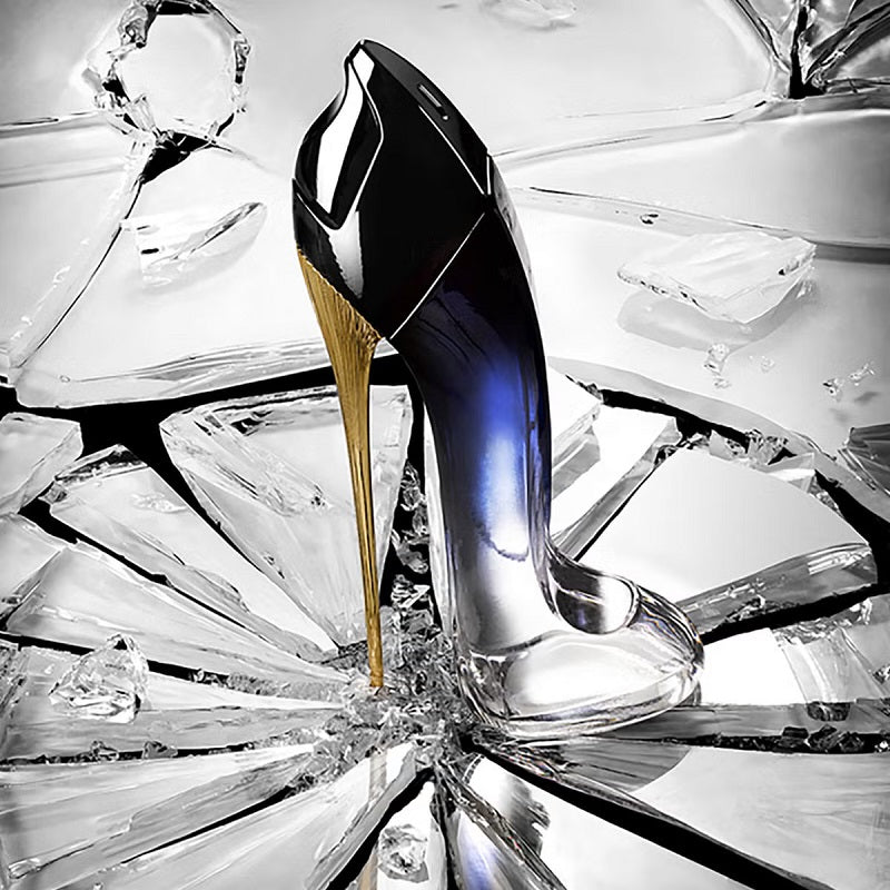 High-heeled shoe with a gold heel on a background of clear crystals