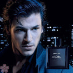 Man with a bottle of Bleu de Chanel perfume against a dark background