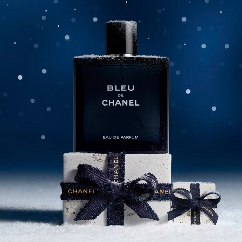 150ml Bleu de Chanel perfume bottle with gift packaging on a snowy background
