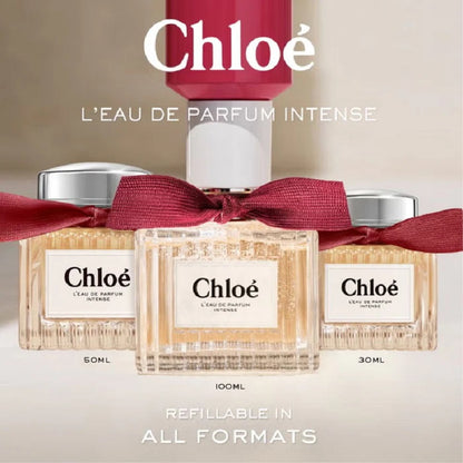 Chloe perfume bottles with a red ribbon on a beige background