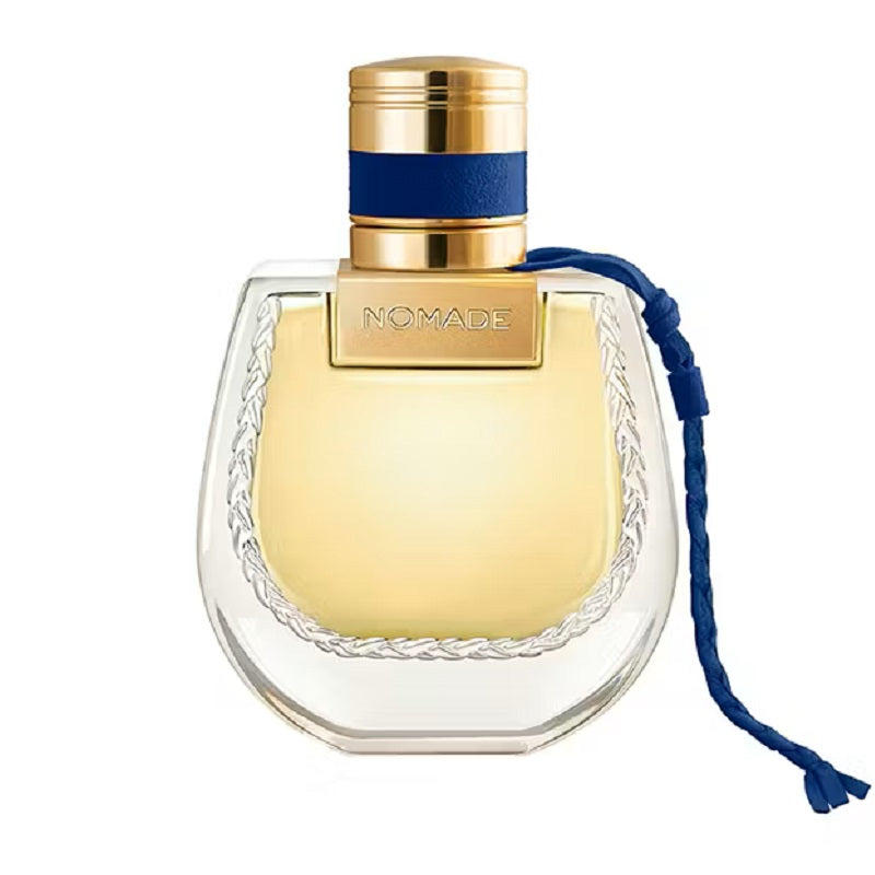 Perfume bottle with gold cap and blue ribbon on a white background