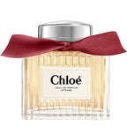 Chloe perfume bottle with a red ribbon on a white background