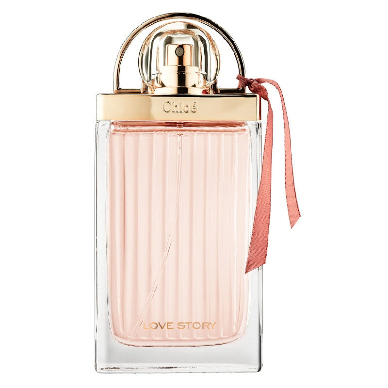 A glass bottle of Chloe 'Love Story Sensuelle' eau de parfum with a gold cap and a pink ribbon tied to the bottle.