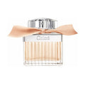 A bottle of Chloé Rose Tangerine Eau de Toilette with a clear glass design and a silver cap, adorned with a peach ribbon.