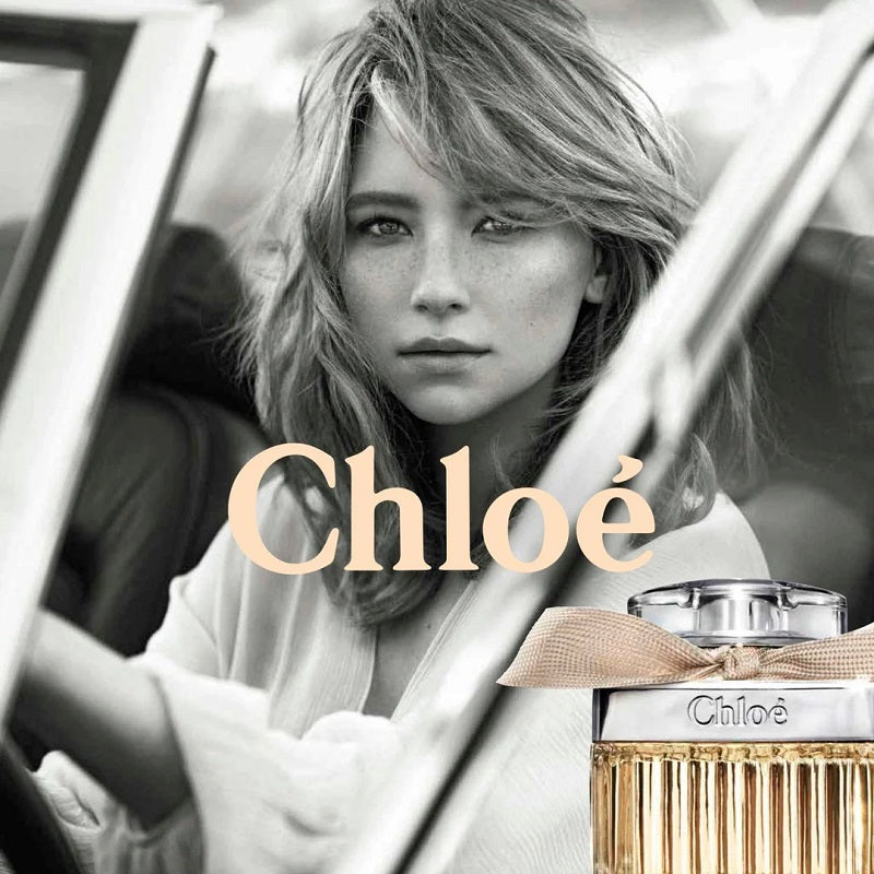 Woman sitting in a car with a Chloé perfume bottle in the foreground