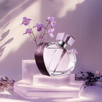 Perfume bottle with purple flowers on a light background