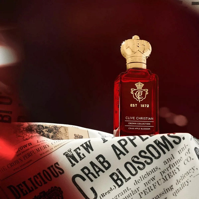 Clive Christian perfume bottle on a newspaper with a dark background