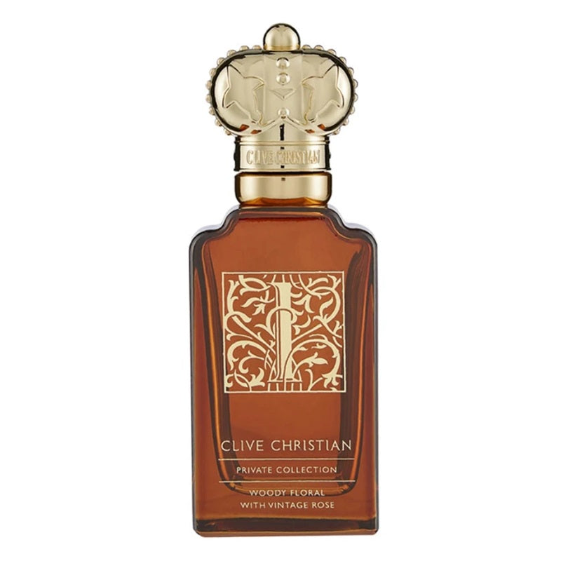 Clive Christian Private Collection Woody Floral with Vintage Rose perfume bottle, featuring an amber brown glass body, a gold ornate monogrammed label, and a detailed gold cap resembling a crown, set against a plain white background.
