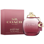 A Coach Wild Rose Eau de Parfum bottle with a gold cap, next to its pink packaging box featuring the Coach logo.