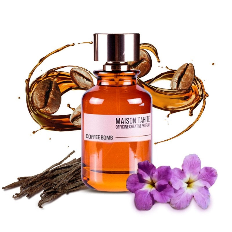 Bottle of Maison Tahite Coffee Bomb perfume with coffee beans, vanilla pods, and purple flowers on a white background