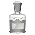 A bottle of Creed Aventus Cologne eau de parfum with a white label and decorative elements, transparent bottle showcasing the liquid inside.