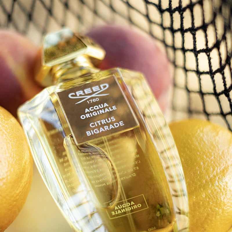 Creed Acqua Originale Citrus Bigarade perfume bottle with lemons in the background