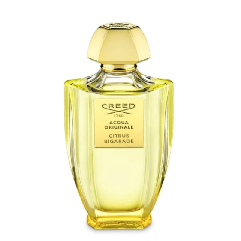 Creed perfume bottle with gold cap on a white background