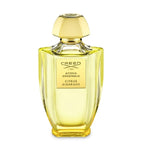 Creed perfume bottle with gold cap on a white background