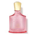 Pink Creed Eladaria perfume bottle with gold cap on a white background