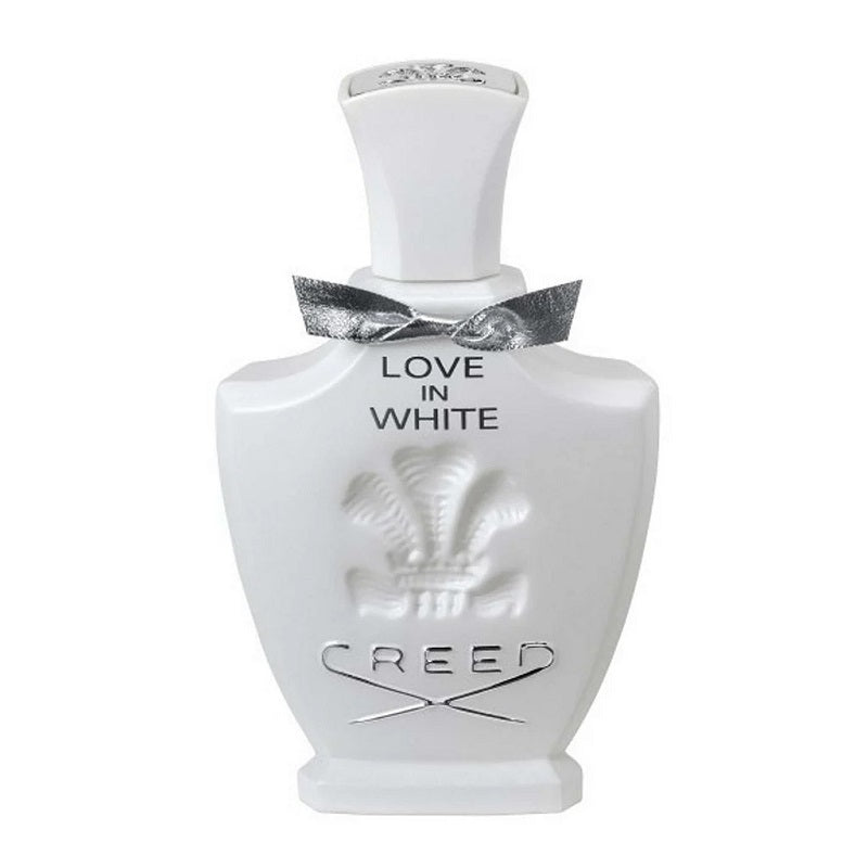 A white bottle of Love In White Eau De Parfum by Creed with a label and a decorative ribbon on top.