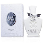 A bottle of 'Love In White' eau de parfum by Creed with the cap off, next to its packaging box. The bottle and box are both white with gold and black detailing.