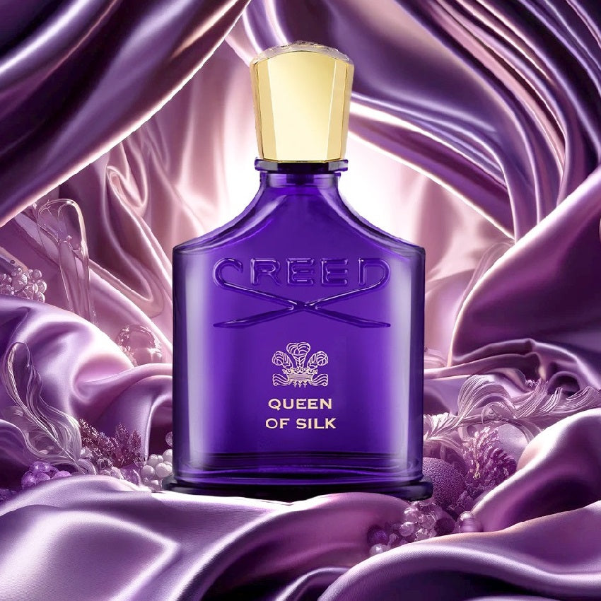 Creed Queen of Silk 75 ml perfume bottle styled on dark wood surface with soft lighting and silk fabric