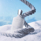 Creed Silver Mountain Water Eau de Parfum featured in a mountain-inspired lifestyle setting with flowing water, fresh air and alpine scenery reflecting its clean, invigorating and sophisticated nature.