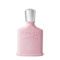 A pink bottle of Creed Spring Flower eau de parfum with a silver cap.