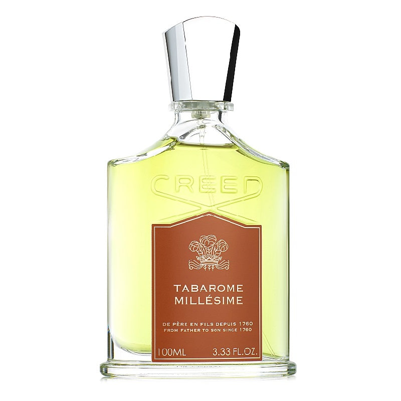 A bottle of Tabarome Millesime Eau de Parfum by Creed with a label in the center, predominantly in a clear glass bottle with a silver cap.