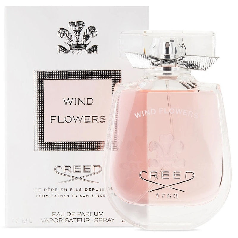 A bottle of Creed Wind Flowers Eau De Parfum with its packaging, displaying the product name and fragrance notes.