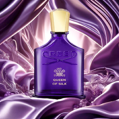 Creed Queen of Silk 30 ml perfume bottle styled on dark wood surface with soft lighting and silk fabric.